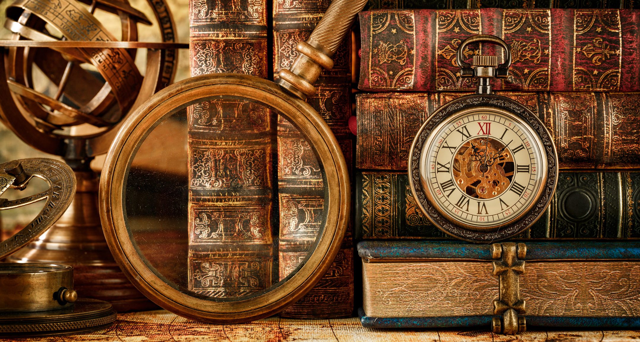 Magnifying glass, pocket watch and old books Magnifying glass, pocket watch and old books